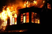 The burning house at night. The flame takes off from windows.