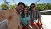 Kristen Ross (Marilyn), Keir Dumont (Jeff), and Liv Edelman (Jessica) posing s Skelton family on a boat.