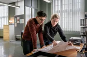 (v.l.n.r.): Philipp Laupheimer (Yassin Trabelsi) und Leonie Winkler (Cornelia Gr&ouml;schel) mit einer Karte der Stadt Dresden im Kommissariat.