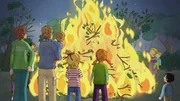 Wie kuschelig warm das Osterfeuer brennt und so sch&ouml;n knistert, freut sich Conni.