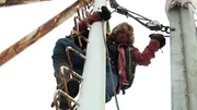 Bear Brown fixing an issue on the mast of the Integrity boat.