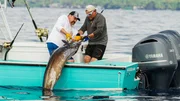 Johnathan Hillstrand and Casey McManus pulling on a fishing rod. Our field producer Bryan Miller filming Johnathan Hillstrand and Casey McManus pulling on a fishing rod. Our field producer Bryan Miller filming