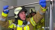 A firefighter opens the door of an elevator in Iserlohn.
