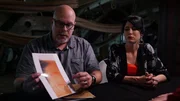 Dave Schrader is with Cindy Kaza as he presents a photograph of the bite mark he sustained during the investigation of the USS Constellation in Baltimore, MD, as seen on Travel Channel's The Holzer Files