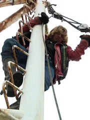 Bear Brown fixing an issue on the mast of the Integrity boat.