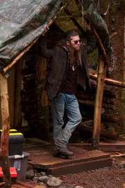 Bam Brown standing at the entrance to his home.