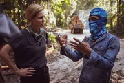 Mariana van Zeller (L) speaking with logger at illegal logging site.