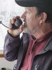 Monte, Relief Captain of the Wizard , hailer in hand.