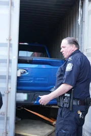 Ein CBP-Beamter unterhält sich, während er das Innere eines Frachtcontainers auf Schmuggelware untersucht. (National Geographic) Ein CBP-Beamter unterhält sich, während er das Innere eines Frachtcontainers auf Schmuggelware untersucht. (National Geographic)