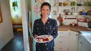 Portrait shot of Molly Yeh with her Fluffy Shredded Pancake with Plum Sauce, as seen on Girl Meets Farm, season 9.