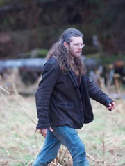 Bam Brown walking on the beach.