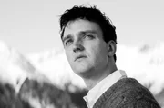 Johannes Leinert (Jan B&uuml;low) auf der Terrasse des Hotel Esplanade. 1962 reist er mit seinem Doktorvater Dr. Strathen zu einem Quantenphysik-Kongress in die Schweizer Alpen, doch der Redner, von dem eine Theorie von Allem erwartet wird, versp&auml;tet sich.