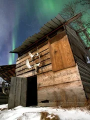 James' cabin with the Northern Lights in the background.