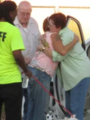 An adopter hugging Tia after Mouse's meet and greet.