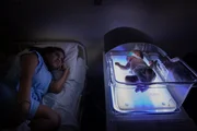 Karine looking at Pierre in the incubator