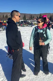 Nations Jordan (L) talks to Courtney Agnes (C) and Pat Moore (R) about race strategy for the North American.