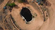 Aerial view of large hole in the ground.
