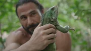Hazen holding a green iguana.
