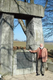 Die Bauernkriege haben das Geschehen am Haushamerfeld im Hausruckviertel gepr&auml;gt. Sepp Forcher vor einem Denkmal, das an das Frankenburger W&uuml;rfelspiel erinnert.