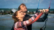 Christian (Max Woelky) erkl&auml;t Eva (Jennifer Ulrich) das Kitesurfen.