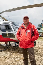 Simrik Air pilot Jason Laing with Simrik Air B3 helicopter at Lukla helipad, Nepal.