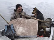 Joey Zuray (L) and Ace (R) take a short break while hunting so ace can take a swim in the river.