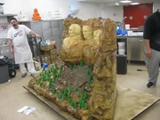 Danny stands next to completed Mt. Rushmore cake.