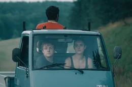 Als Kim (Emma Flo&szlig;mann) Flake (Jakob Schmidt, li.) dazu &uuml;berredet zum Bodensee zu fahren, l&auml;sst sich Philipp (Daniel Rodic, hi.), der alles mitgeh&ouml;rt hat, die Chance auf einen Roadtrip nicht entgehen und dr&auml;ngt sich den beiden auf.