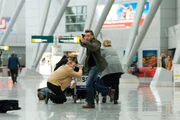 Hartwig (Florian Panzner) flieht vor den Helden und schie&szlig;t im Flughafengeb&auml;ude wild um sich...