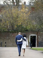 In this Monday file photo Britain's Prince Harry and Meghan Markle walk away after posing for the media in the grounds of Kensington Palace in London. In this Monday file photo Britain's Prince Harry and Meghan Markle walk away after posing for the media in the grounds of Kensington Palace in London.