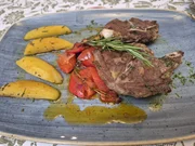 Die Hauptspeise "Ziegenkotelette vom Grill mit fruchtigem Ratatouille und Rosmarinkartoffeln" vom Klosterhof zur Post in Bayrischzell.