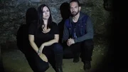 Nick and Katrina in front of stone basement wall.