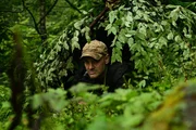 Ed Stafford lying on the ground under shelter