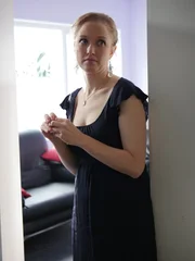 Makaela stands in the hallway.