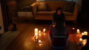 RECREATION - Tina Bowen (Christina Giordana Zaros) and Karen Bowen (Olivia Morgan Bell) sit on living room floor surrounded by candles, attempting to contact their deceased mother using a spirit board.
