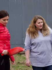 Aspen(r.) shows Julia (l.) how to do her farm chores.