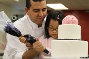 Buddy and Leah finishing the cake.