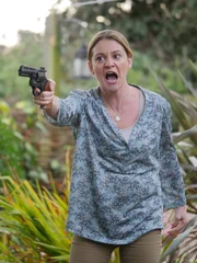 Vennie points the gun.