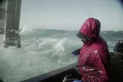 Zack Larson, Engineer on the Brenna A, tries to dodge the spray of a messy sea.