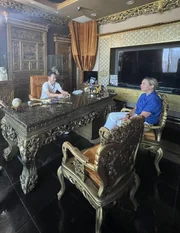Mariana Van Zeller sits with Johnny Dang in his eccentrically decorated office.