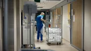 Krankenschwester schleppt den Wagen mit dem Bettzeug