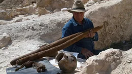 Dr Zahi Hawass sitting on the steps of the newly discovered unfinished tomb, KV-65 with all the artefacts found at the bottom of it. Valley Of The Kings The Lost Tombs, S01. Episode 1.