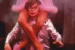 Austin Powers (Mike Myers) mit einer Frau auf den Schultern.