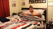 Latonya in bed reading. Latonya in bed reading.