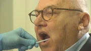 Oliver Bendixen gibt freiwillig seine Speichelprobe ab.