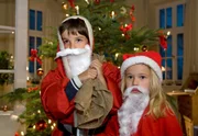 Als Weihnachtsm&auml;nner verkleidet organisieren der kleine Jonas Heilmann und die kleine Lisa Schroth die Bescherung f&uuml;r die Gro&szlig;familie. Jonas Heilmann (Anthony Petrifke, links) und Lisa Schroth (Ella Zirzow).