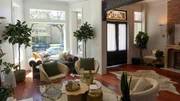 Interior shot of the enclosed front porch. Walls were made of just wood planks for a cabin feel, a new arched door was installed, and dark tile to add to the look. After 6, as seen on Windy City Rehab, Season 4.