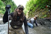 Wes Richardson and Carlos Minor preparing the dive site at the edge of McKinley Creek.