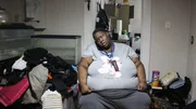 Syreeta on phone in bedroom