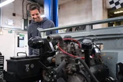 Marc (Elvis) Priestley works on the Landrover in the garage.